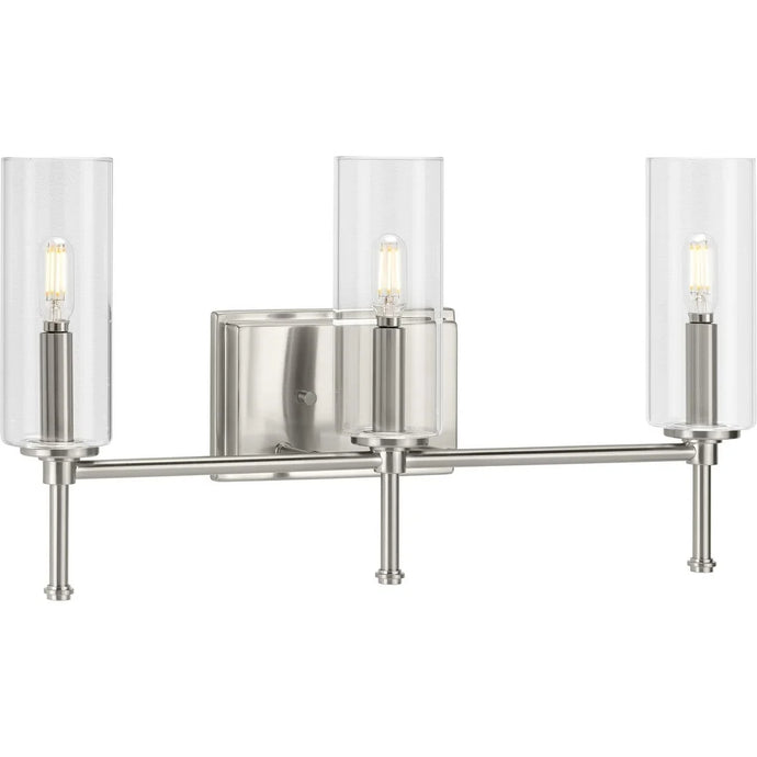 Elara Collection Three-Light Brushed Nickel Clear Glass New Traditional Bath Vanity Light - 22.125 in x 5.12 in x 11.5 in